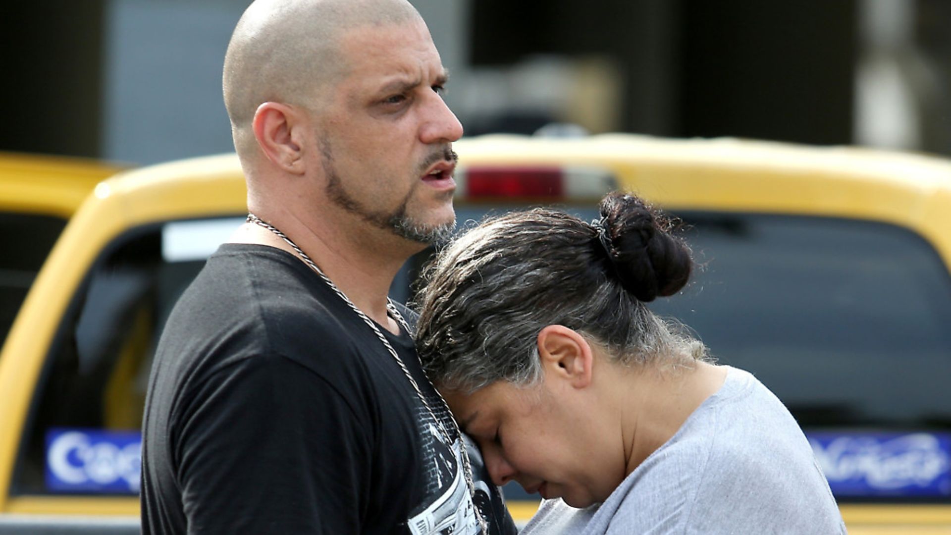 Ray Rivera, DJ at the Pulse nightclub, is consoled by a friend outside of the Orlando Police Department, 2016. - Credit: TNS via Getty Images