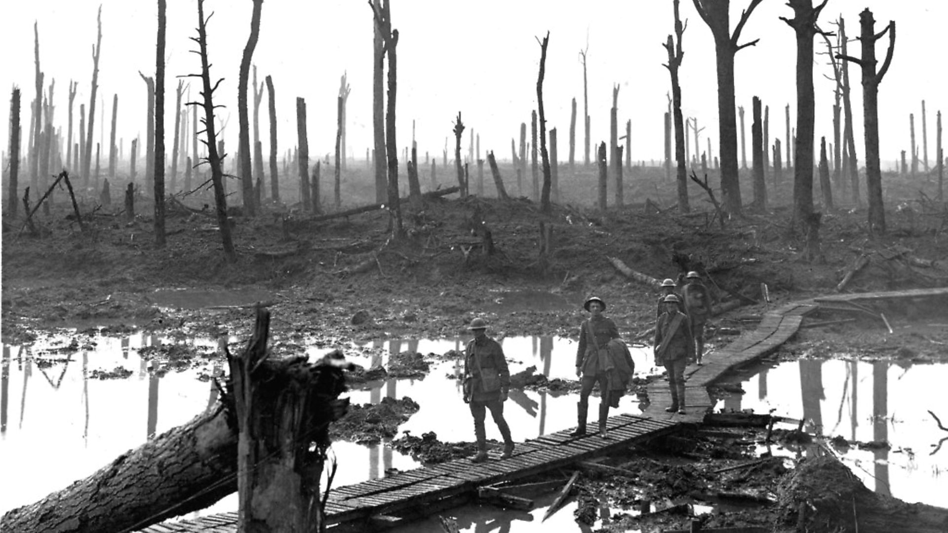 The Third Battle of Ypres 1917, known popularly as Passchendaele. Australian troops over a duckboard track at Chateau Wood. - Credit: Topham Picturepoint/Press Association Images