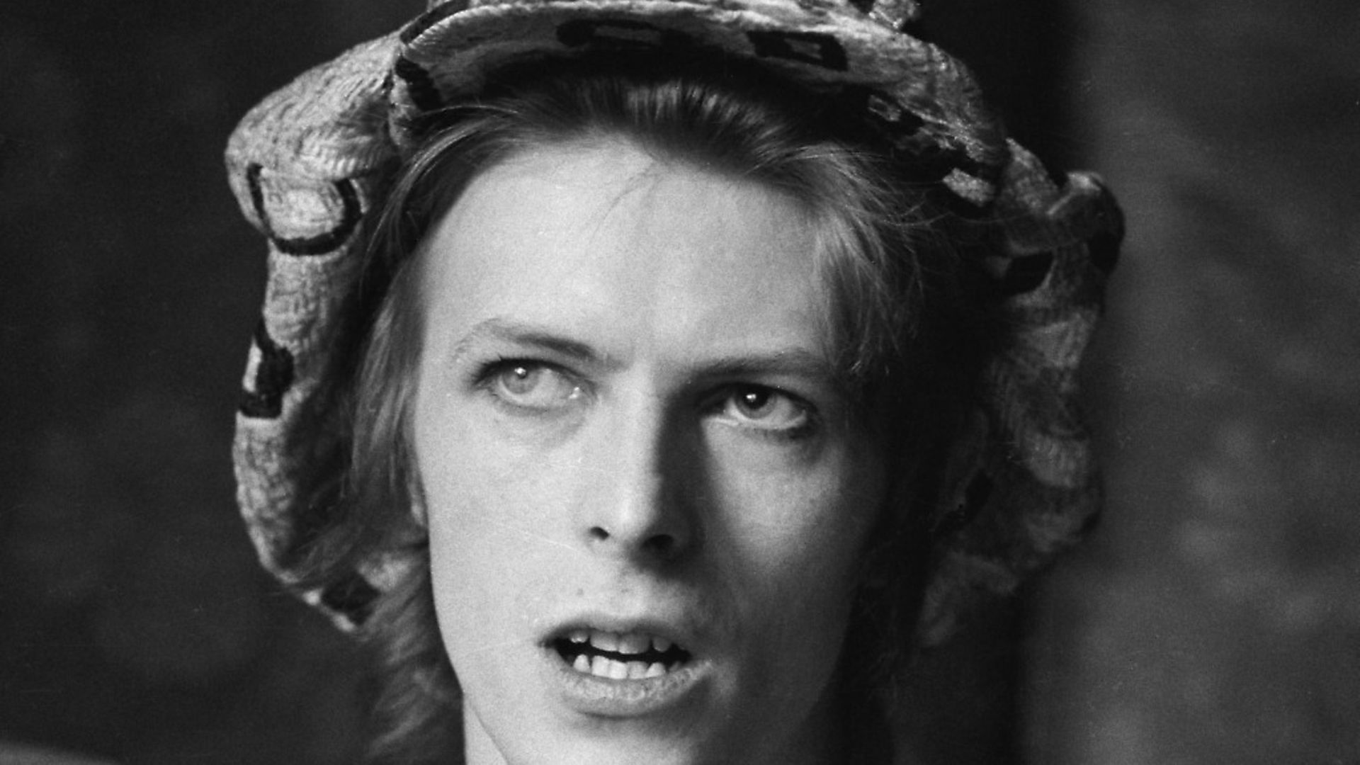 Singer David Bowie (1947 - 2016) being interviewed at his ground floor flat at Haddon Hall, where he has been redecorating the ceiling in silver paint, Beckenham, London, 24th April 1972. (Photo by Michael Putland/Getty Images) - Credit: Getty Images