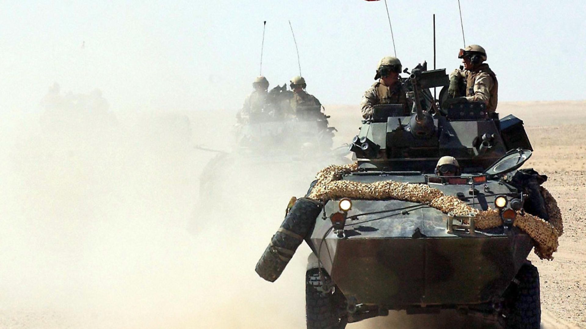 US marines of the 3rd Light Armoured Reconnaissance Battalion (3rd LAR) patrol through the desert of Kuwait on 14 March 2003. More than 150,000 American and British soldiers are currently situated in the northern desert of Kuwait. According to the US Defense Department, the soldiers could start an attack on Iraq at any time. - Credit: DPA/PA Images