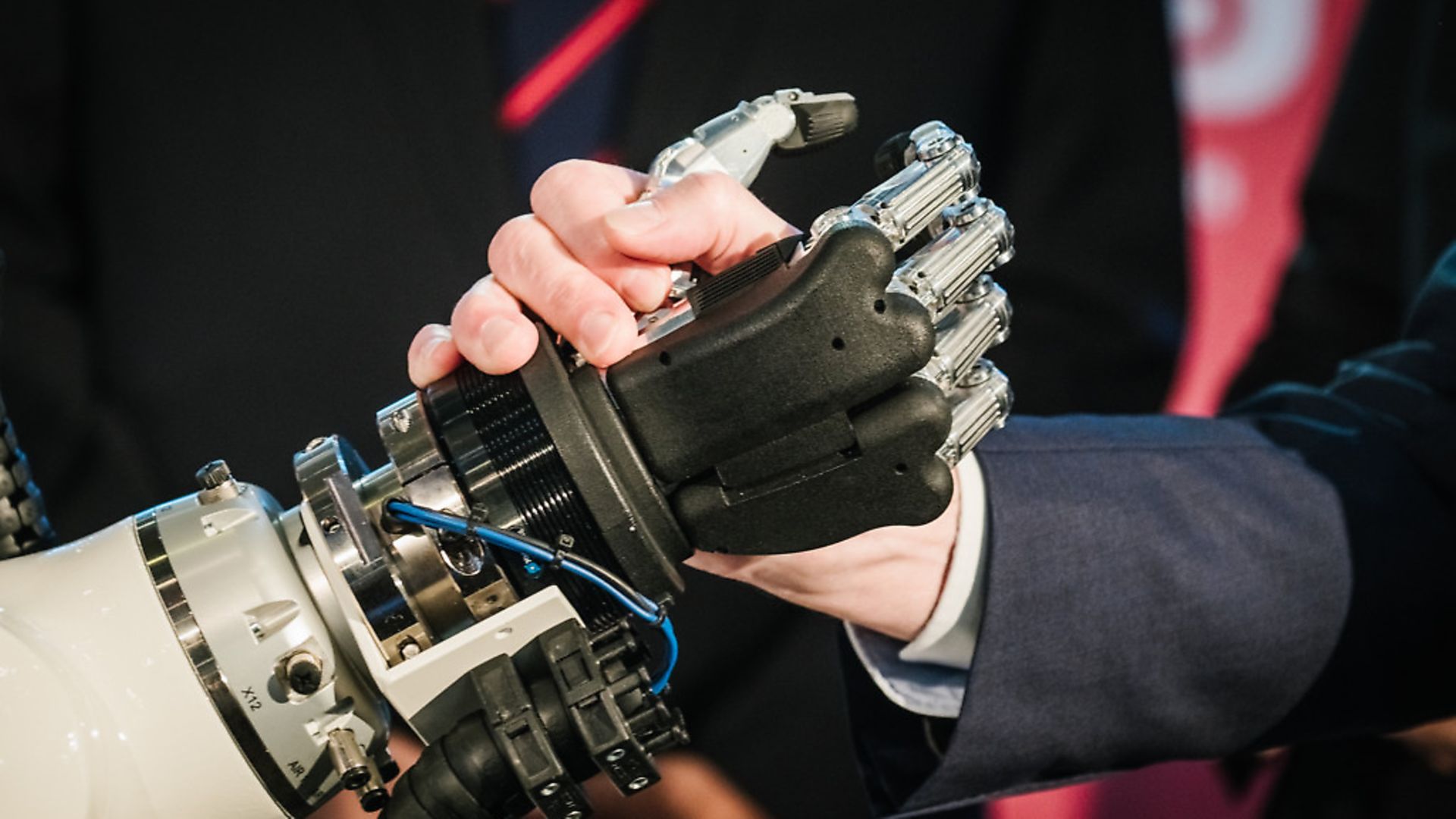 A hand shakes the hand of a robot during at a trade fair in Germany 	Photo: Ole Spata/dpa - Credit: DPA/PA Images