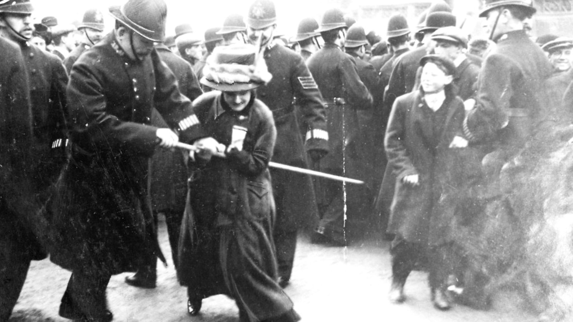 A suffragette struggling with a policeman on 'Black Friday', Westminster, London, 18th November 1910. The Conciliation Bill (which would have given the vote to women who occupied premises for which they were responsible) was shelved by the Prime Minister, Herbert Asquith. On learning of this, the Women's Social and Political Union marched on the House of Commons, a riot followed and the women were assaulted - some being severely beaten - by police and others. The newspaper Votes for Women reported that 115 women and 4 men were arrested. The WSPU quickly learned the lessons of that day and a policy decision was made to pursue their campaign using different tactics. Large deputations were considered to be too dangerous and from this moment the suffragettes went underground and waged 'guerrilla warfare' (their phrase) against the Liberal Government. (Photo by Museum of London/Heritage Images/Getty Images) - Credit: Heritage Images/Getty Images