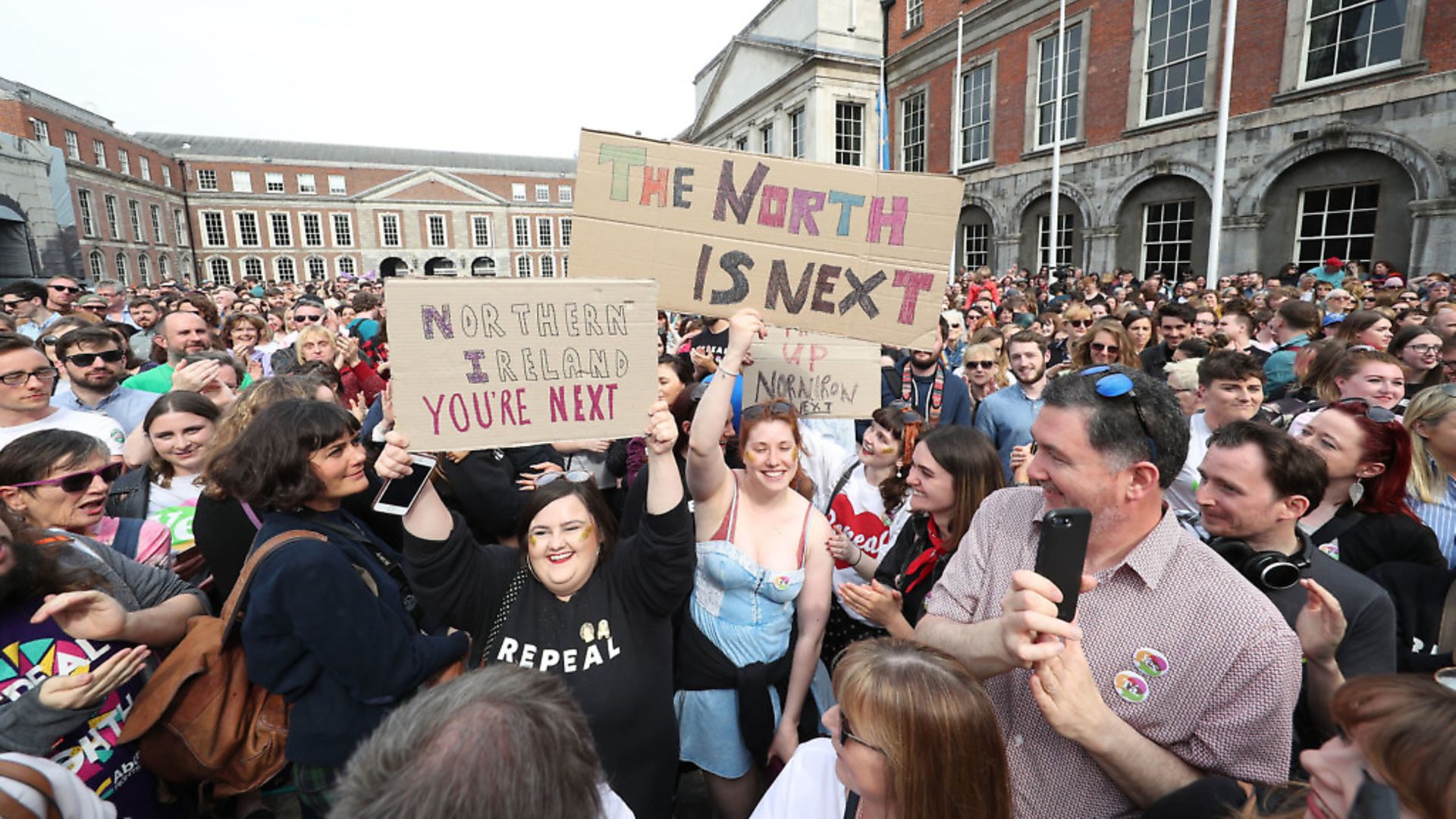 Members of the public celebrate at Dublin Castle after the results of the referendum on the 8th Amendment of the Irish Constitution which prohibits abortions unless a mother's life is in danger. - Credit: PA Wire/PA Images