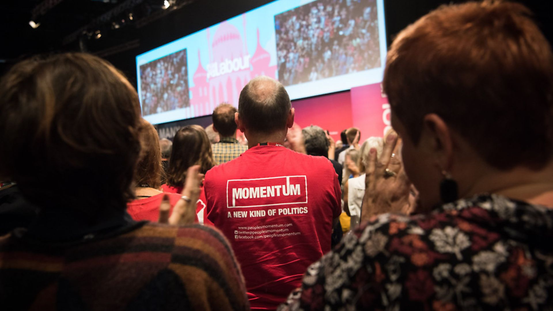 A Momentum supporter watches as Jeremy Corbyn gives his Leader's Speech. Photo: Matt Crossick/EMPICS Entertainment. - Credit: Empics Entertainment