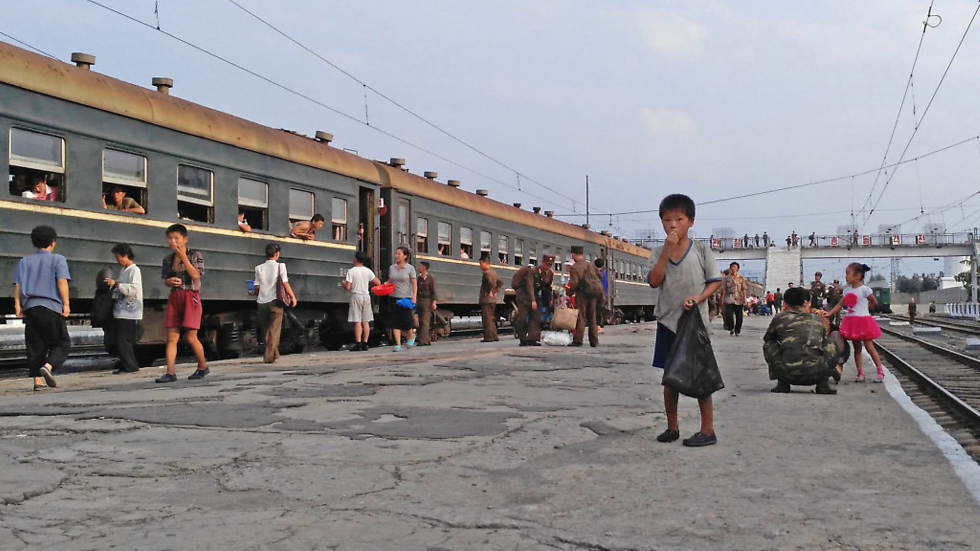HAMHUNG, NORTH KOREA - AUGUST 21:  A little boy begs for food on the platform in Hamhung Railway Station on August 21, 2015 in Hamhung, North Korea.  North and South Korea today came to an agreement to ease tensions following an exchange of artillery fire at the demilitarized border last week.  (Photo by Xiaolu Chu/Getty Images) - Credit: Getty Images