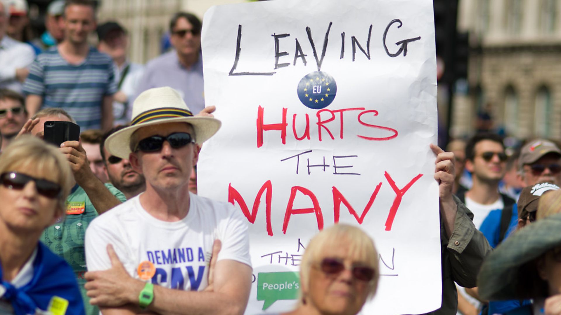 A sign reading "Leaving hurts the many" is held up during a demonstration against Brexit. Photograph: See LI/PA. - Credit: PA Images
