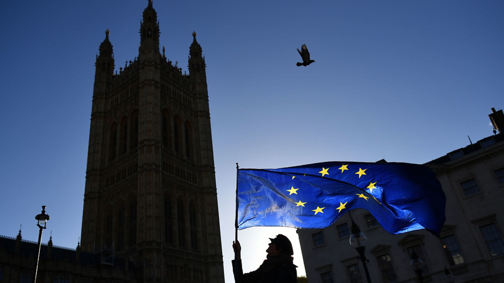 An anti-Brexit protestor waves an EU flag in Westminster. Photograph: Dominic Lipinski/PA Wire. - Credit: PA