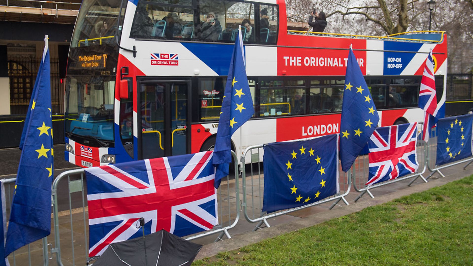 A tour bus passes anti-Brexit banners outside the Houses of Parliament. Photograph: Dominic Lipinski/PA. - Credit: PA Wire/PA Images