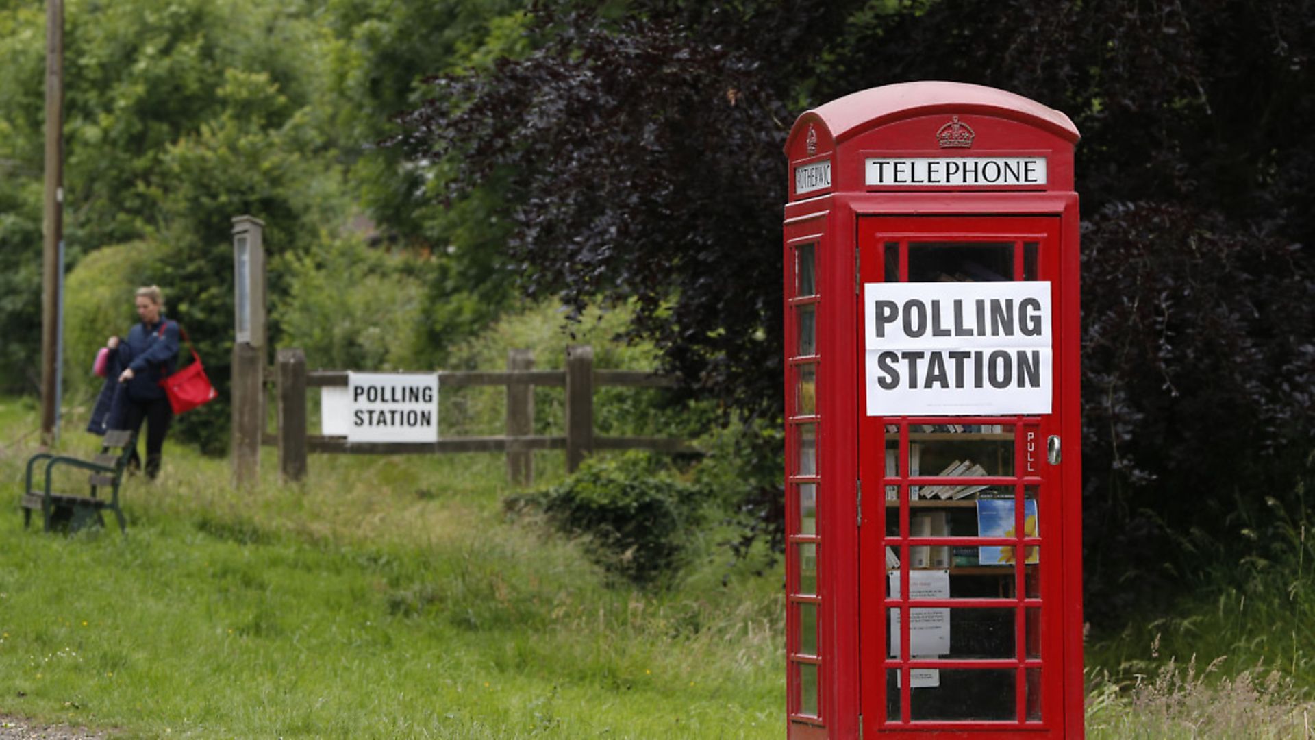 A polling station sign is seen on a telephone box outside the polling station. Photo: ADRIAN DENNIS/AFP/Getty Images. - Credit: AFP/Getty Images