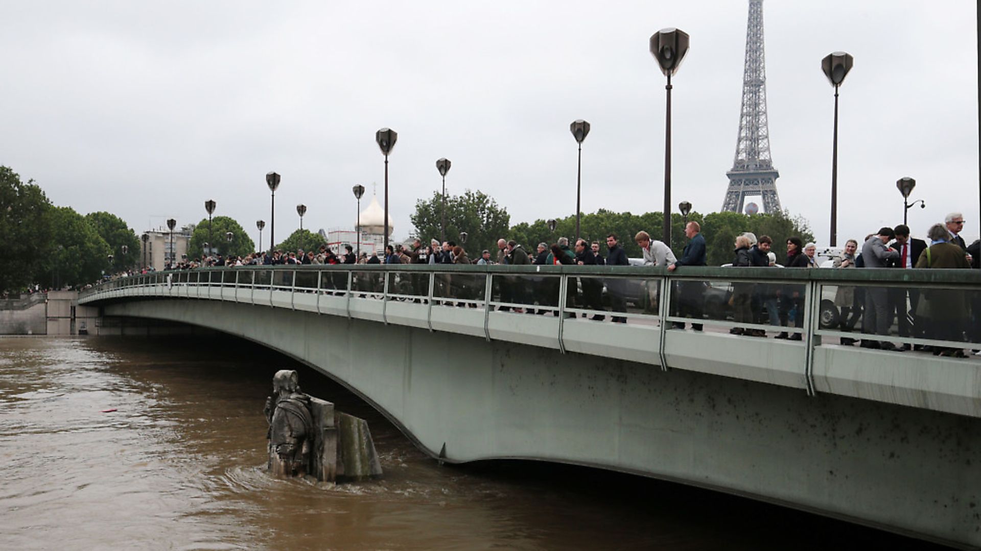 People look at waters of the river Seine rising on the statue of the Zouave at the Alma bridge in Paris on June 3, 2016. Photo: JOEL SAGET/AFP/Getty Images - Credit: AFP/Getty Images