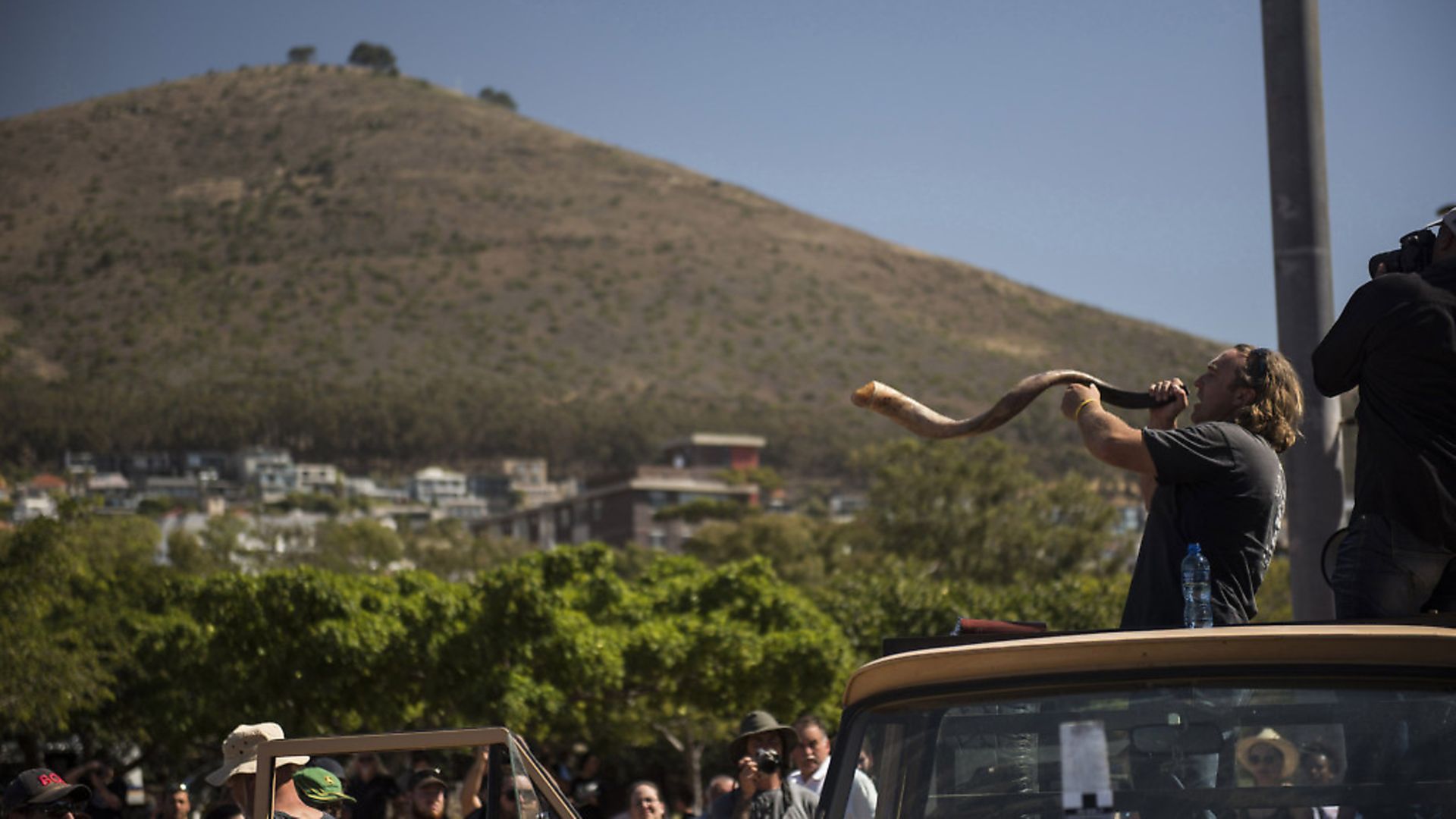 A protester blows a horn as South African farmers & farm workers attend a demonstration at the Green Point stadium to protest against farmer murders in the country, on October 30, 2017, in Cape Town. 
Picture: DAVID HARRISON/AFP/Getty Images - Credit: AFP/Getty Images