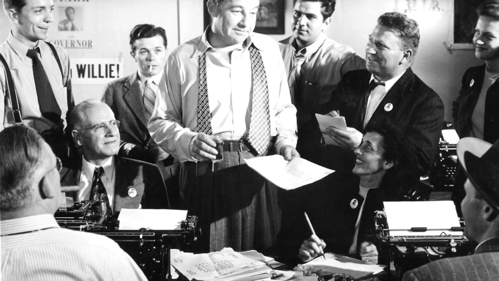 Broderick Crawford standing amongst a group of unknown actors in a scene from the film 'All The Kings Men', 1949.  (Photo by Columbia Pictures/Getty Images) - Credit: Getty Images