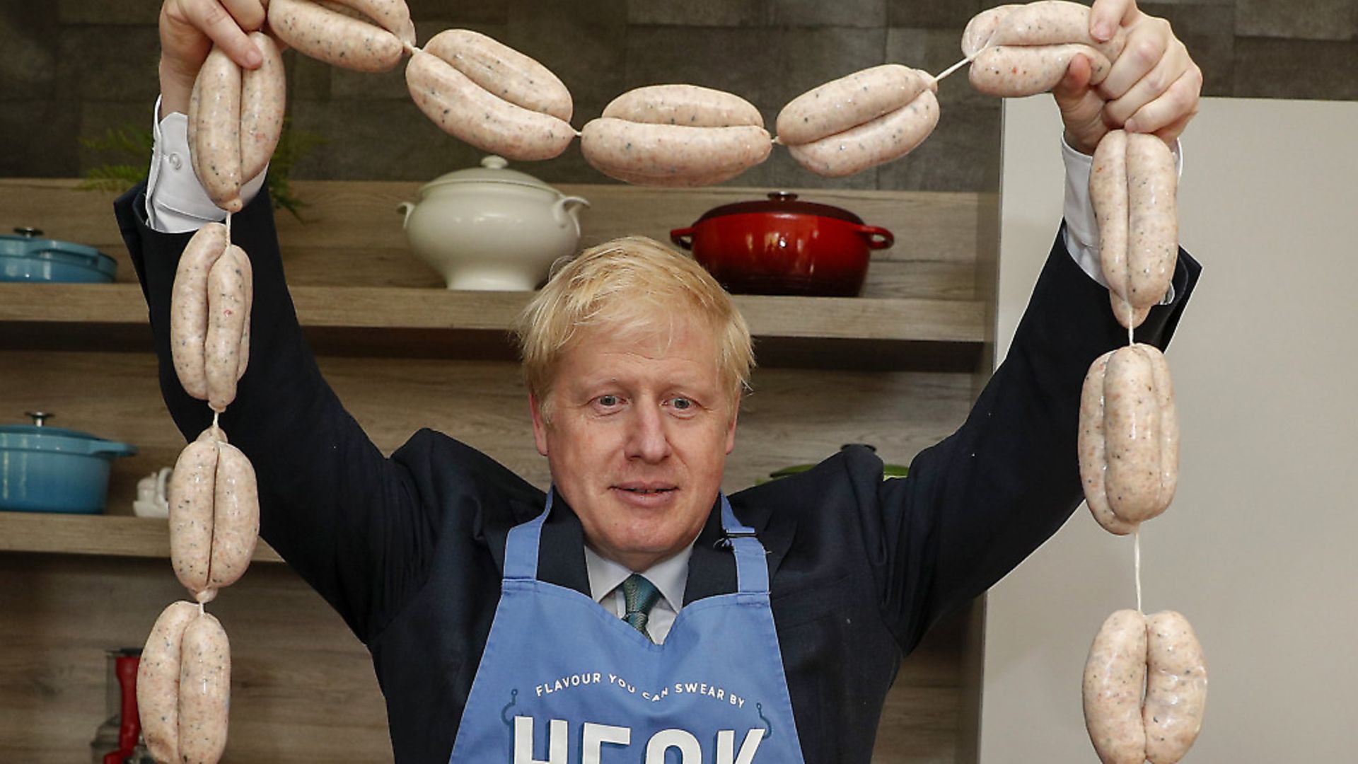 Boris Johnson holding up a string of sausages around his neck during a visit to Heck Foods Ltd. Photograph: Darren Staples/PA. - Credit: PA Wire/PA Images