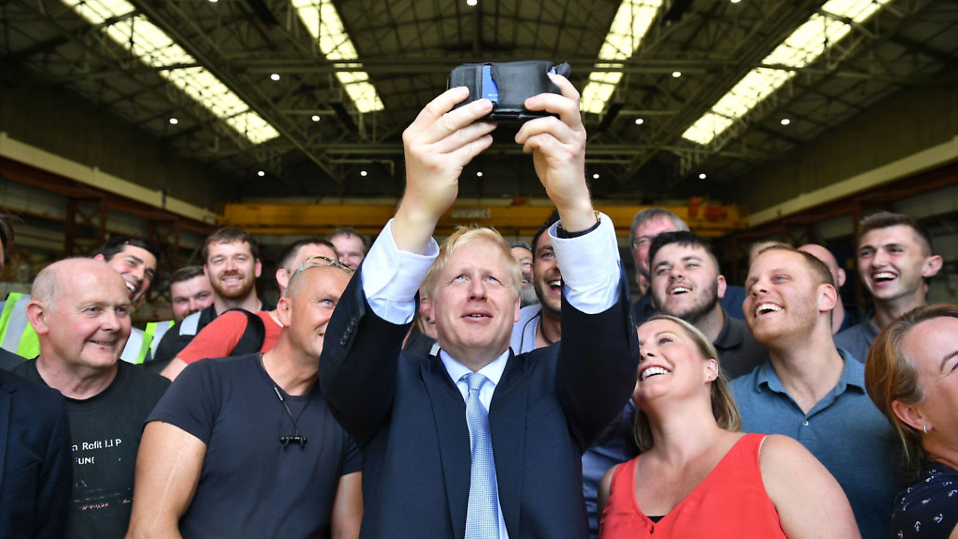 ISLE OF WIGHT, UNITED KINGDOM - JUNE 27: Conservative party leadership contender Boris Johnson takes a selfie with workers at the Wight Shipyard Company at Venture Quay during a visit to the Isle of Wight on June 27, 2019 on the Isle of Wight, United Kingdom. Boris Johnson and Jeremy Hunt are the remaining candidates in contention for the Conservative Party Leadership and thus Prime Minister of the UK. Results will be announced on July 23rd 2019. (Photo by Dominic Lipinski - WPA Pool/Getty Images) - Credit: Getty Images