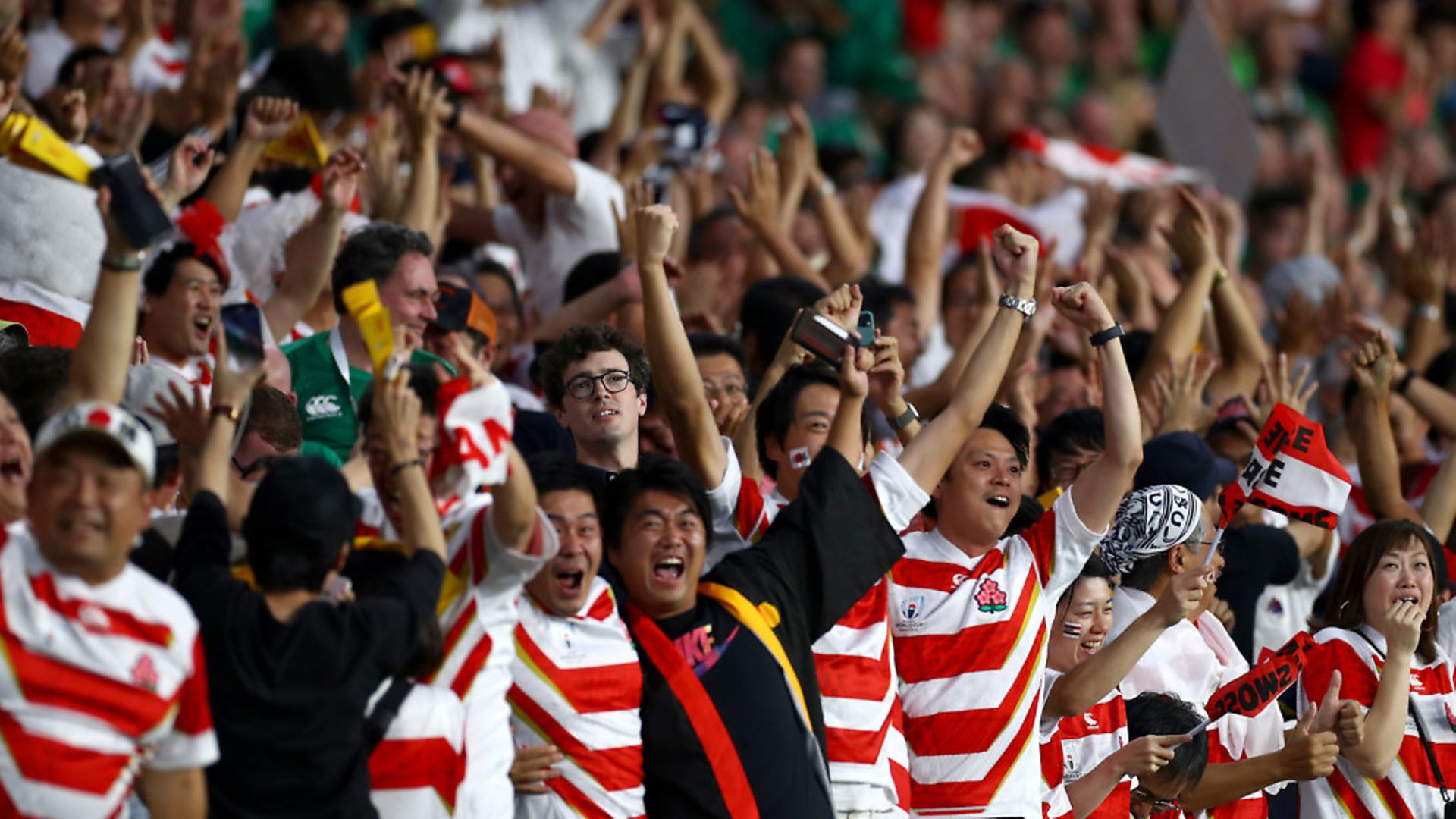 Japanese fans celebrate after their team's first try during the Rugby World Cup 2019. Photo by Clive Rose - World Rugby/World Rugby via Getty Images) - Credit: World Rugby via Getty Images