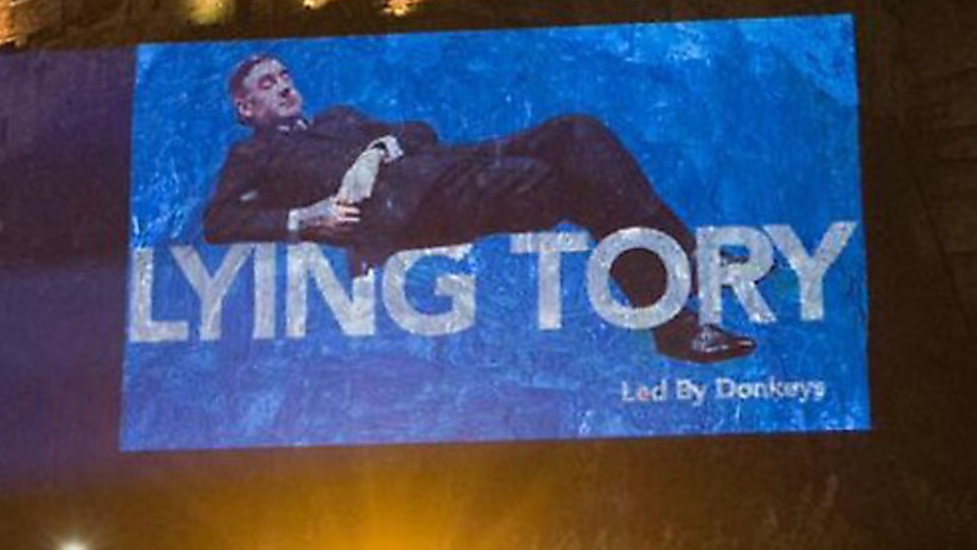 A projection of Jacob Rees-Mogg showing disregard for parliament is projected on to Edinburgh Castle. Photograph: ByDonkeys/Twitter. - Credit: Archant