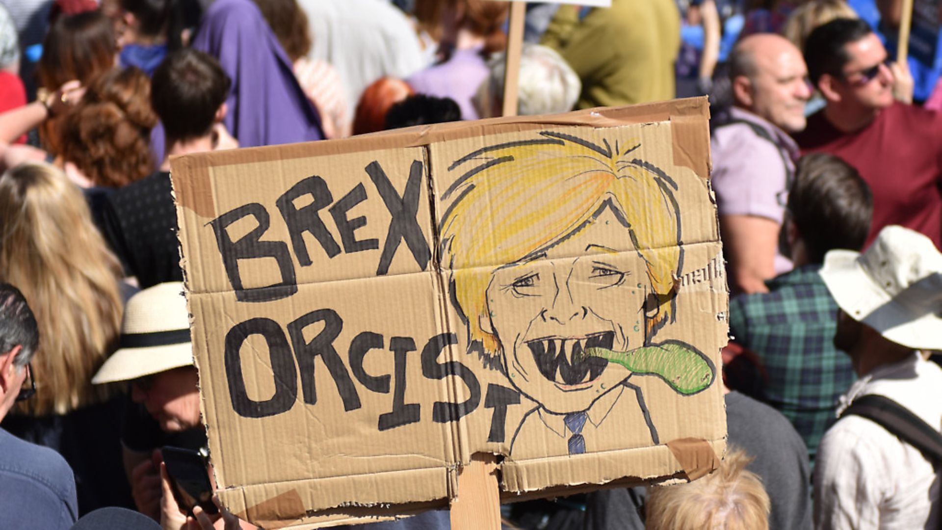 A protester holds a placard of Boris Johnson with the words "Brex Orcist" outside Downing Street. (Photo by John Keeble/Getty Images) - Credit: Getty Images