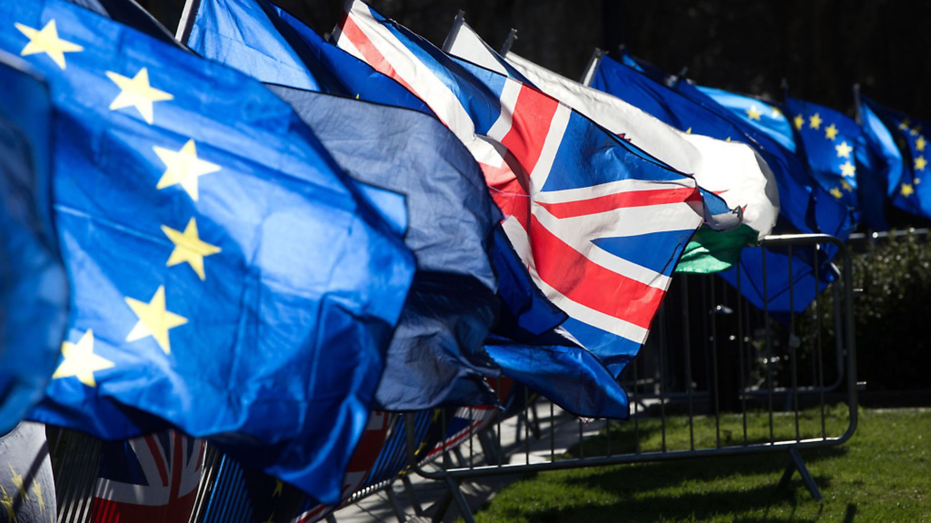 Anti-Brexit campaigners wave Union and European Union flags outside the Houses of Parliament. Photograph: Jonathan Brady/PA. - Credit: PA Archive/PA Images