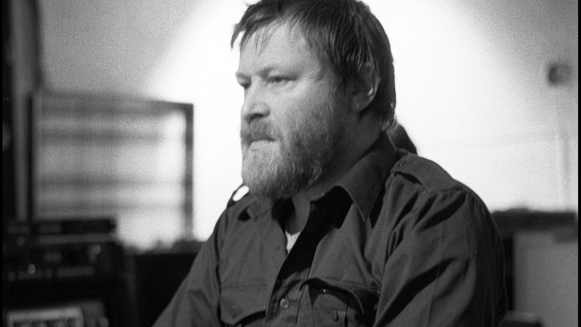 Conny Plank at work by the mixing desk in the control room of his recording studio at Wolperath in 1982 - Credit: Redferns