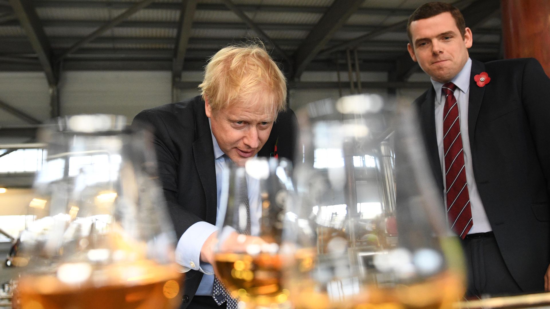 Prime minister Boris Johnson tastes whisky at the Roseisle Distillery in Scotland near Moray with Douglas Ross, leader of the Scottish Conservative Party MP (right) - Credit: PA