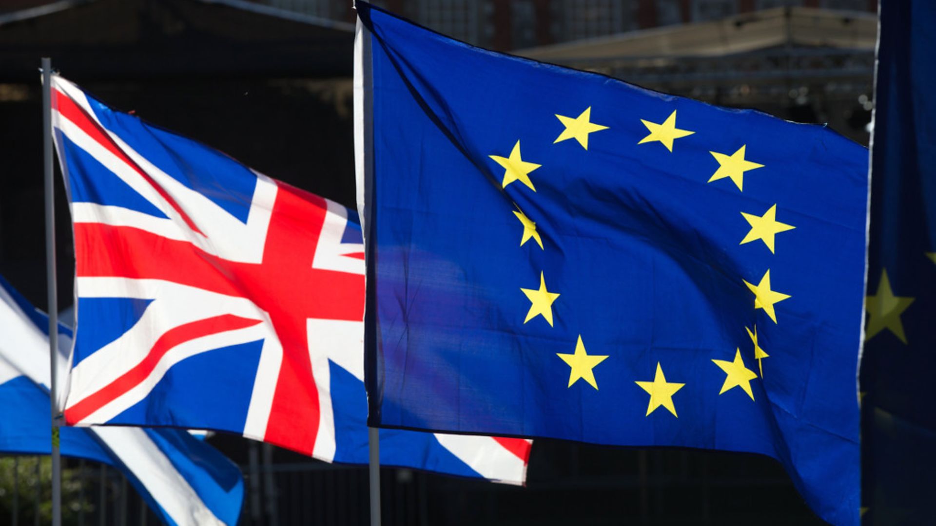 Anti-Brexit campaigners wave Union and European Union flags outside the Houses of Parliament - Credit: PA Wire/PA Images