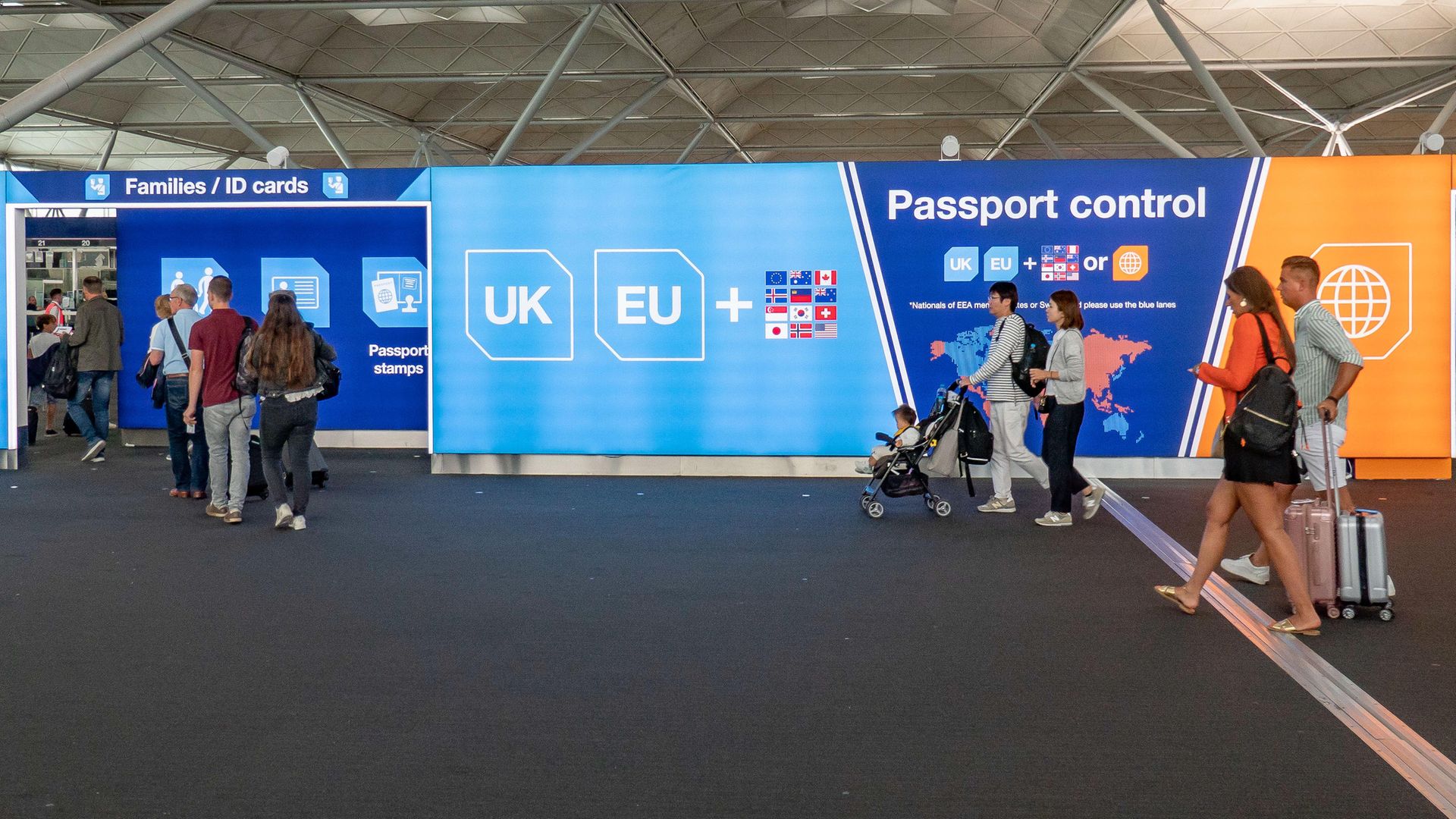 Pre-Brexit signs at passport control at Stansted airport in England - Credit: NurPhoto via Getty Images