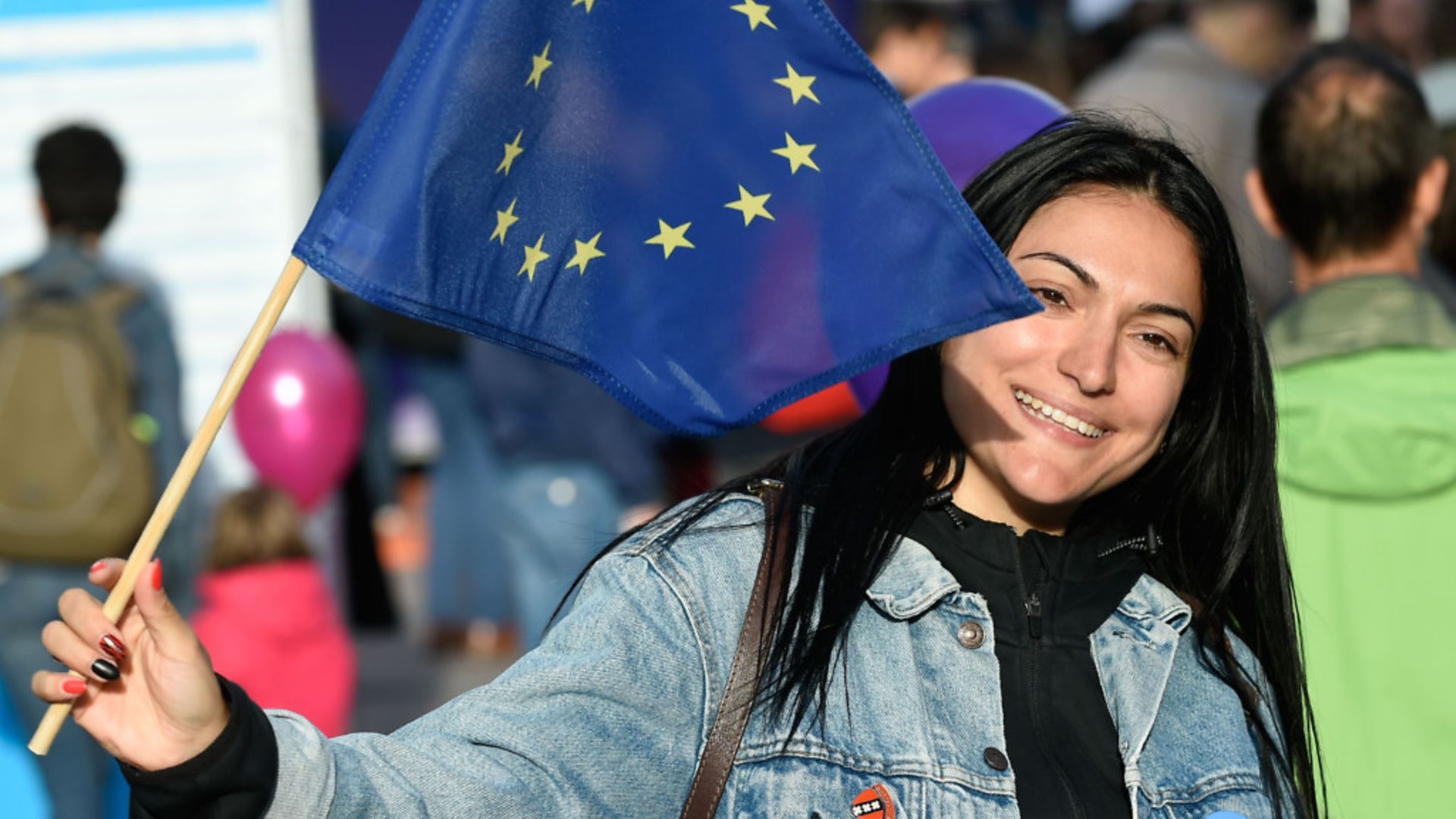 A woman holds an European flag outside the European Parliament - Credit: AFP/Getty Images