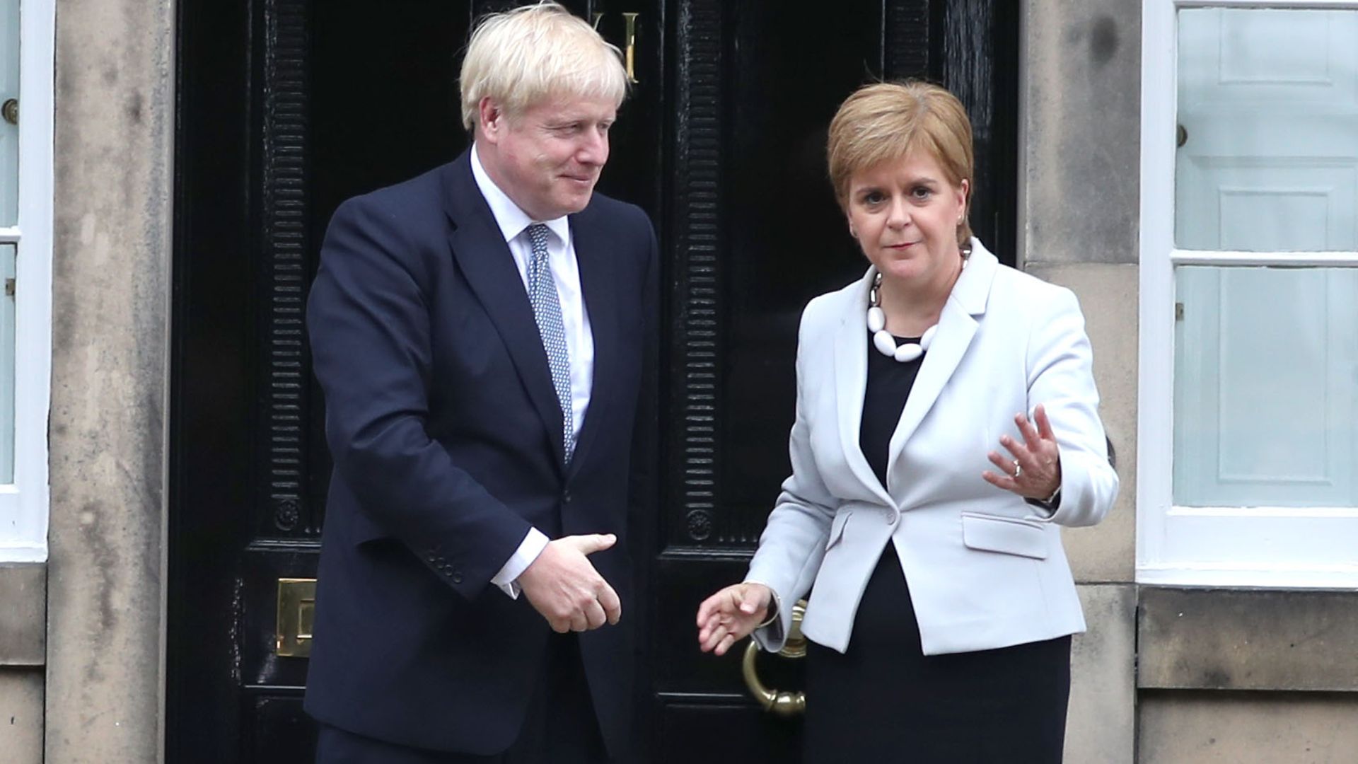 Scotland's first minister Nicola Sturgeon welcomes prime minister Boris Johnson outside Bute House in Edinburgh ahead of their meeting - Credit: PA