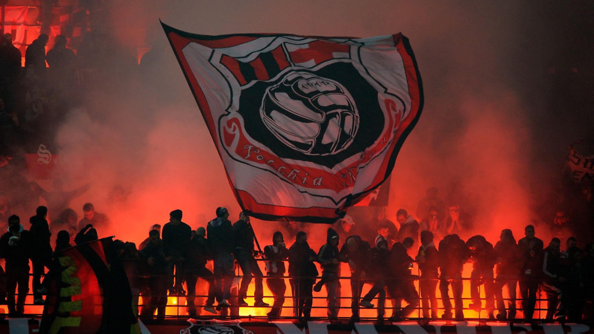 MILAN, ITALY - NOVEMBER 14:  Fans of AC Milan show their support during the Serie A match between FC Inter and AC Milan at Stadio Giuseppe Meazza on November 14, 2010 in Milan, Italy.  (Photo by Claudio Villa/Getty Images) - Credit: Getty Images