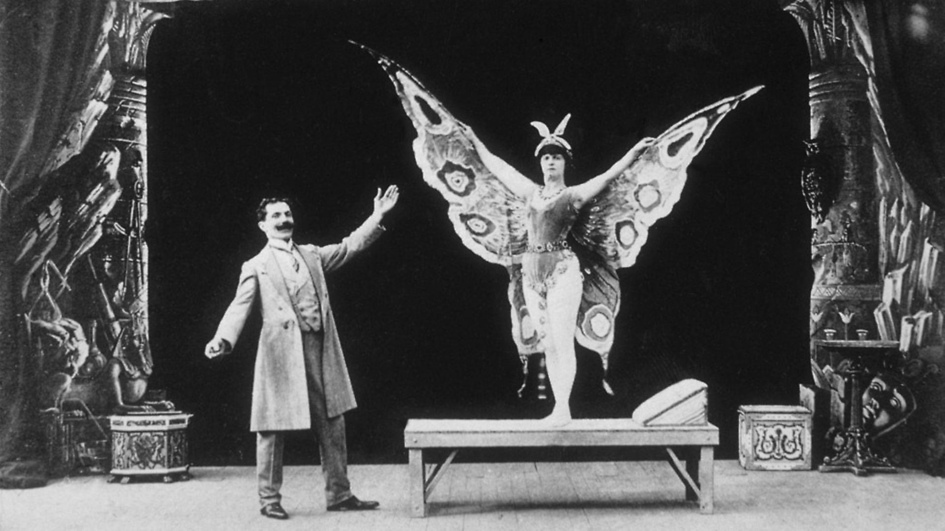 The early French cinematographer Georges Melies playing the role of a magician with a female assistant. (Photo by © Hulton-Deutsch Collection/CORBIS/Corbis via Getty Images) - Credit: Corbis via Getty Images