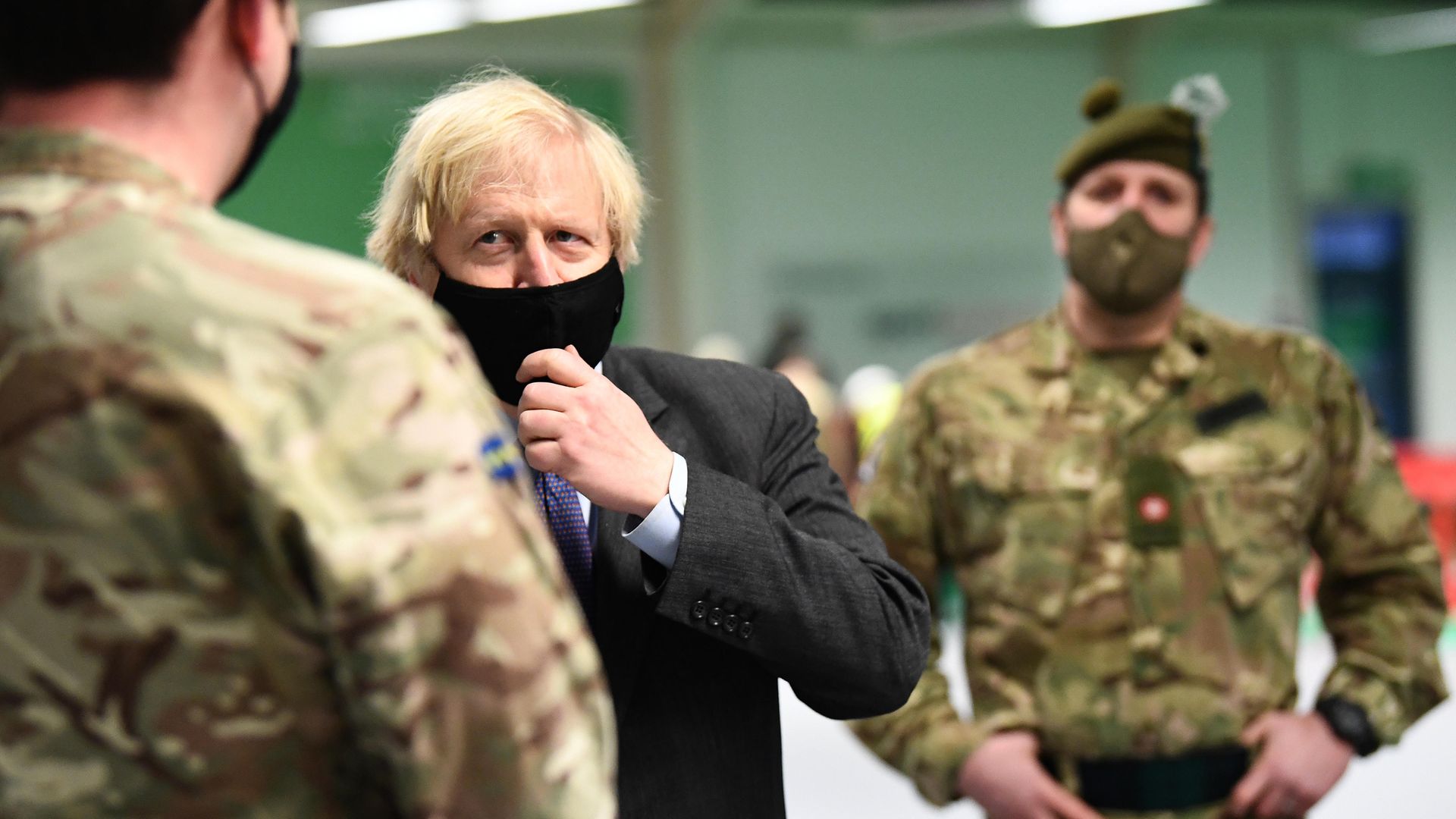 Prime minister Boris Johnson meets troops setting up a vaccination centre in the Castlemilk district of Glasgow on his one day visit to Scotland - Credit: PA