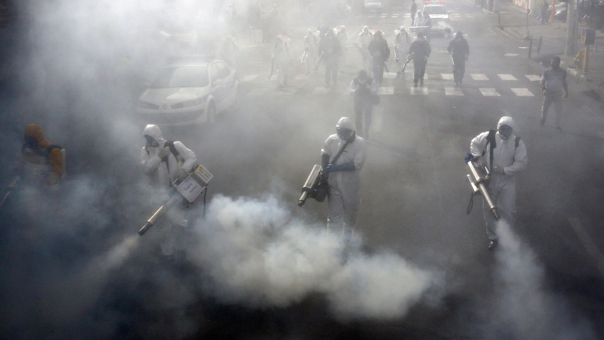 Iranian Firefighters disinfect streets in Tehran in a bid to halt the spread of coronavirus in March 2020 - Credit: AFP via Getty Images