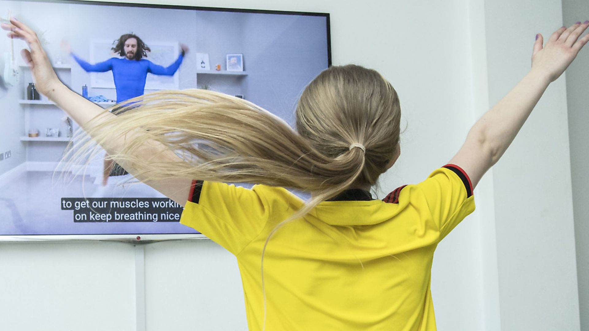 An eight-year-old watches Joe Wicks performing live on YouTube. Photograh: Ian West/PA Wire. - Credit: PA