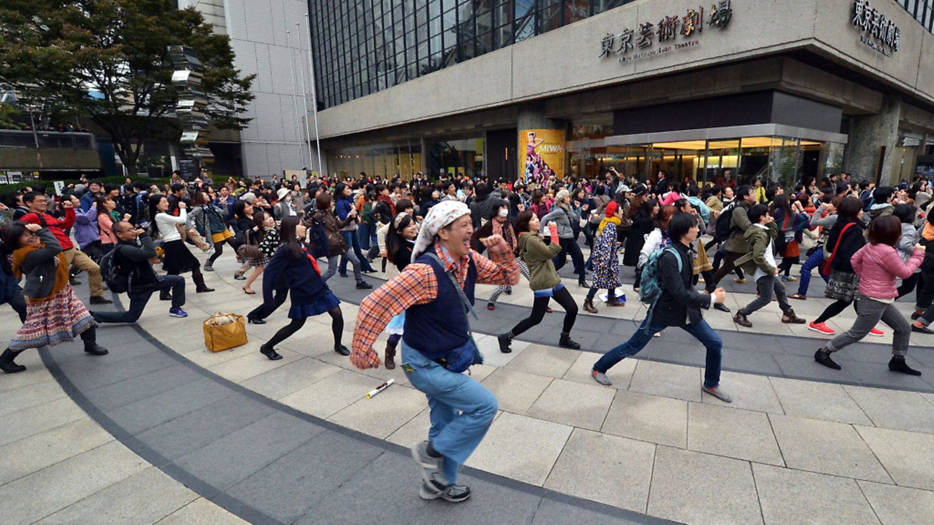 People dance Yellow Magic Orchestra's (YMO) "Rydeen" in a flashmob event coreographed by Ryohei Kondo in Tokyo. (Photo YOSHIKAZU TSUNO/AFP via Getty Images) - Credit: AFP via Getty Images