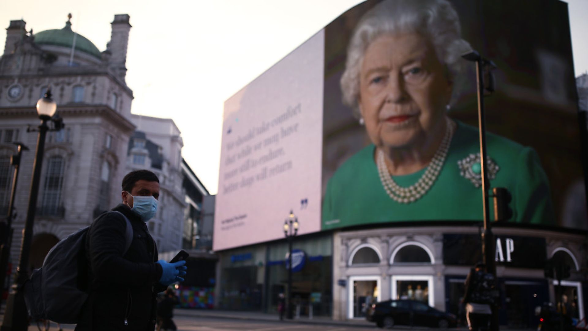 An image of Queen Elizabeth II and quotes from her broadcast on Sunday to the UK and the Commonwealth in relation to the coronavirus epidemic are displayed on lights in London's Piccadilly Circus. Photograph: Yui Mok/PA. - Credit: PA