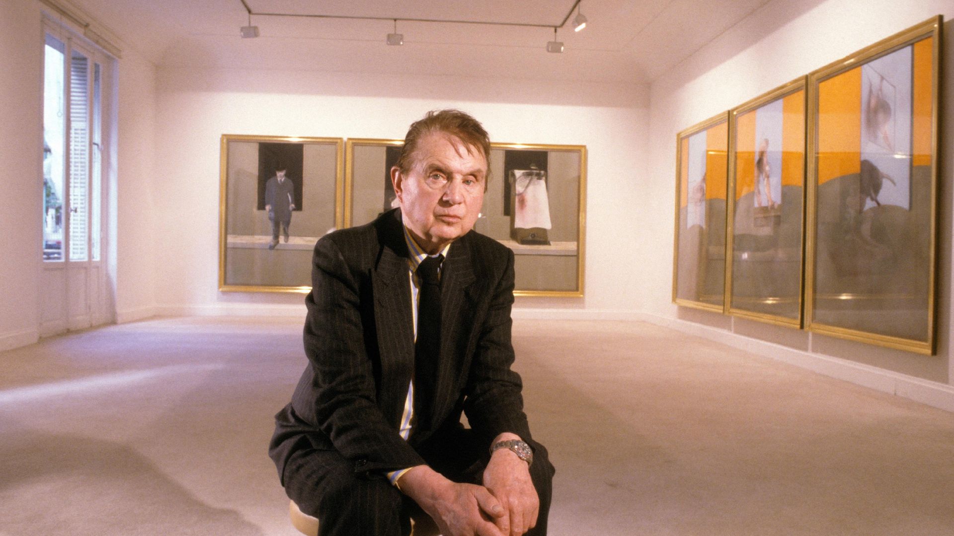 Painter Francis Bacon posing in front of paintings in a Paris gallery in 1987 - Credit: Gamma-Rapho via Getty Images