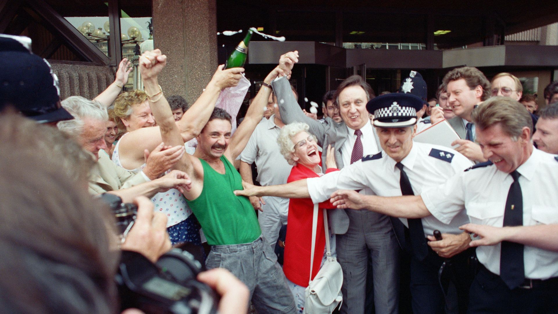 Comedian Ken Dodd celebrates with supporters after being acquitted of tax evasion charges at Liverpool Crown Court - Credit: Getty Images