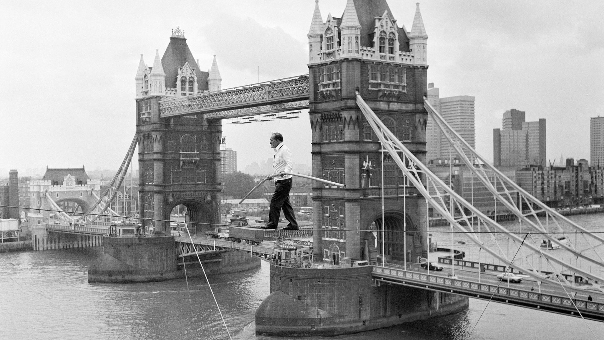 Karl Wallenda on a tightrope 100ft above the ground, near Tower Bridge, London, in 1976 - Credit: Mirrorpix via Getty Images