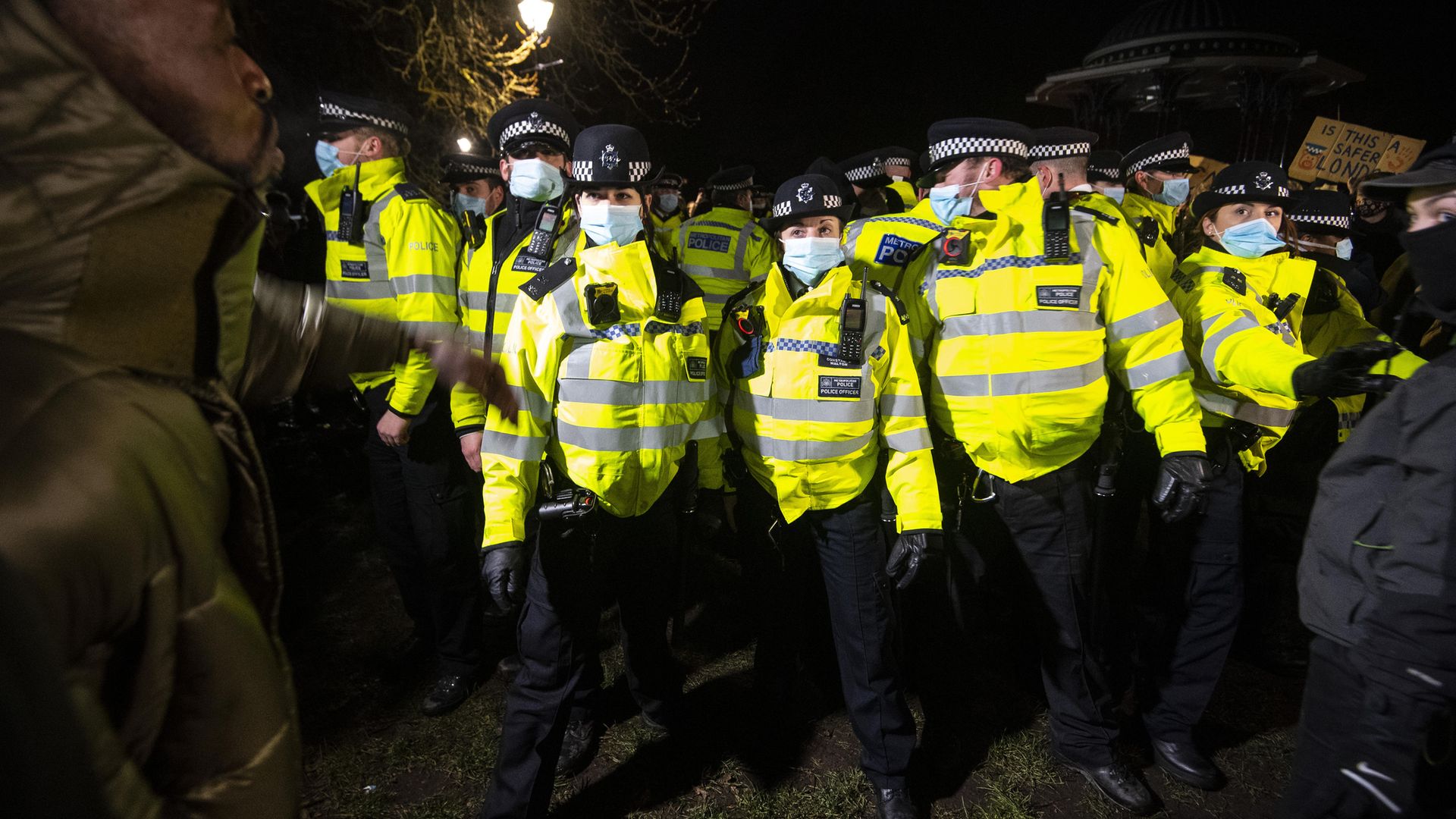 People clash with police as they gather in Clapham Common, London, after the Reclaim These Streets vigil for Sarah Everard was officially cancelled - Credit: PA