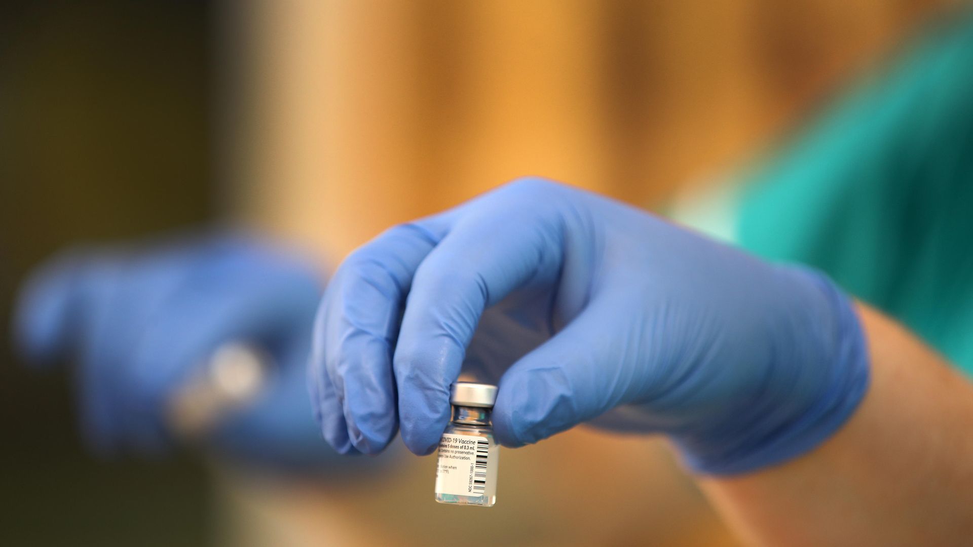 A coronavirus vaccine is prepared by a health care assistant - Credit: PA