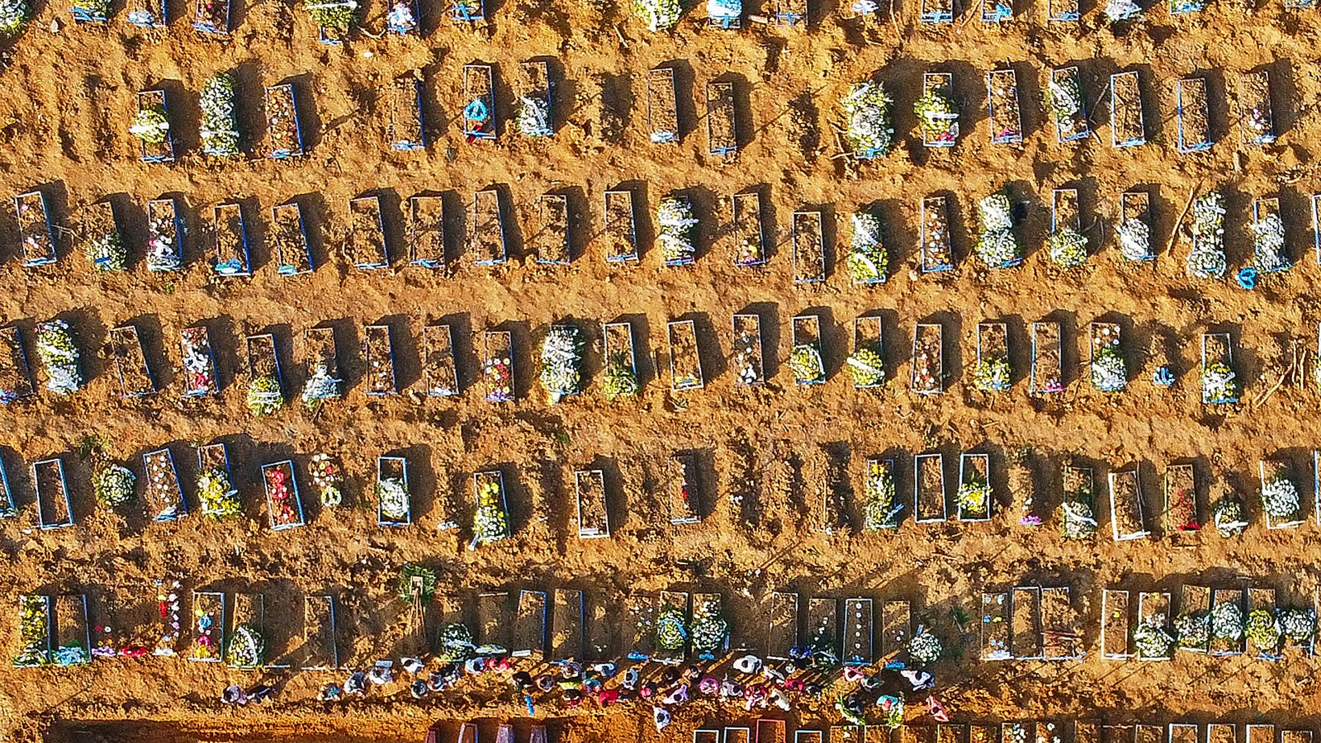 An aerial view of coffins at a mass burial in Parque Taruma cemetery, Manaus, Brazil. Graves are being dug at a new area of the cemetery for Covid deaths. - Credit: AFP via Getty Images