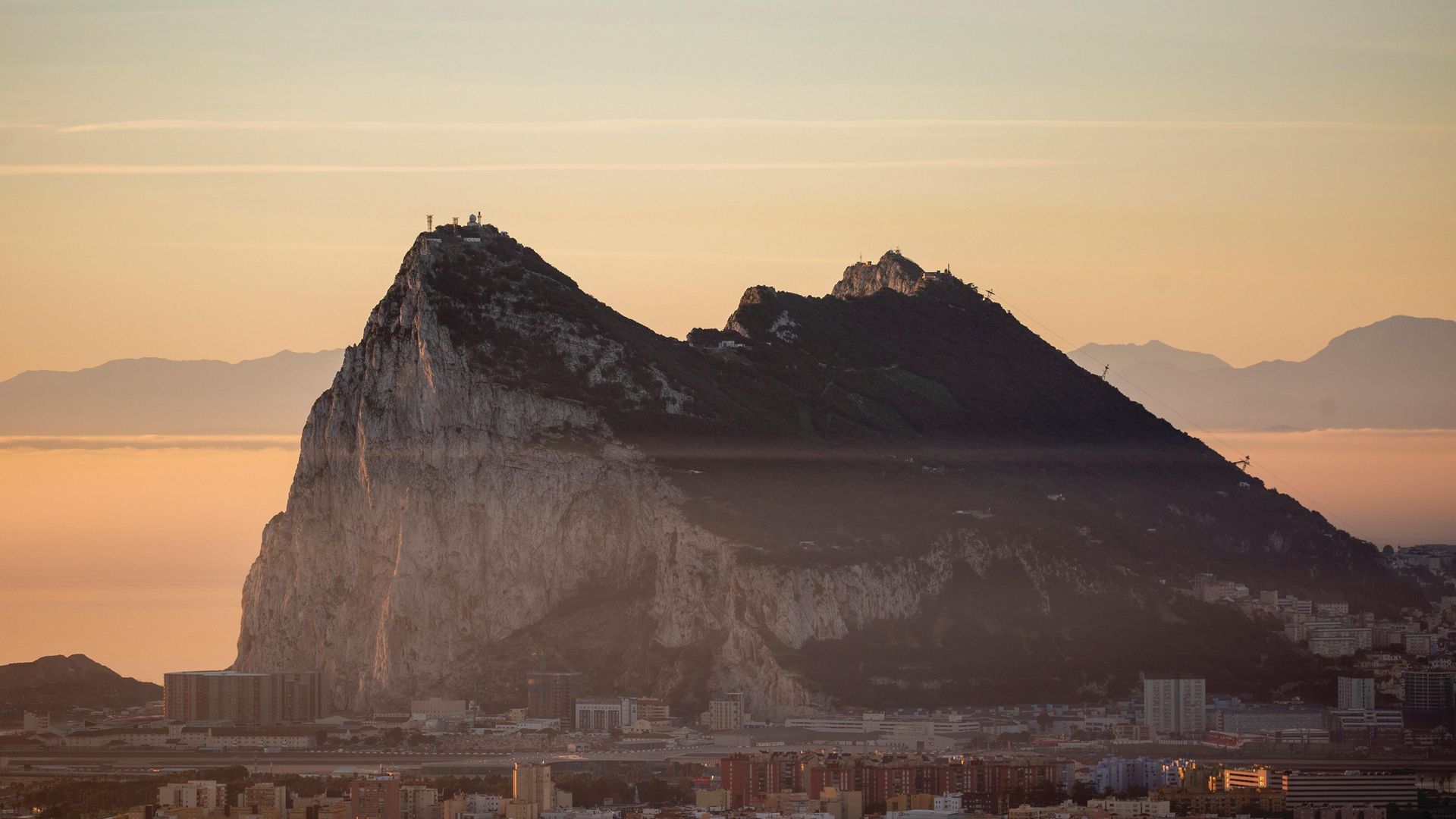 The Gibraltar Rock is seen at sunrise from the Spanish side - Credit: Getty Images