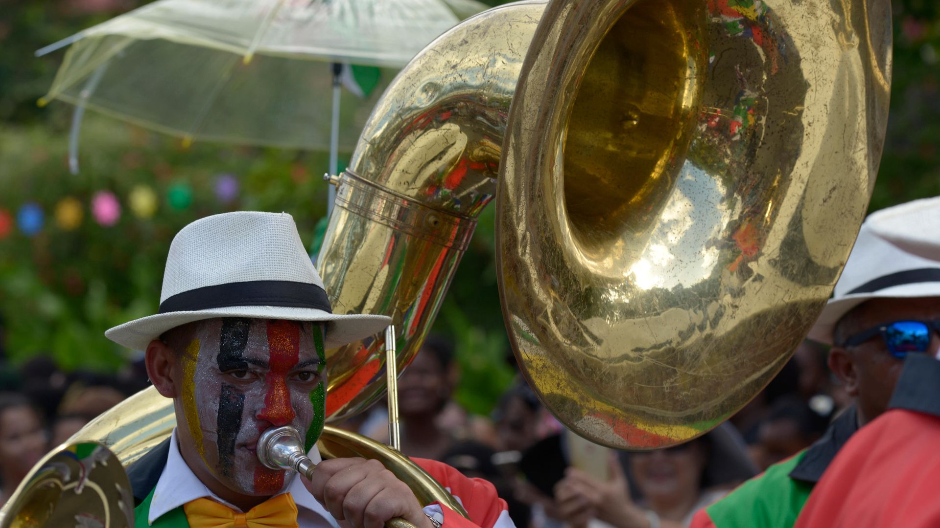 Man wearing a costume playing the tuba, parade at the International Carnival of Victoria, Seychelles. - Credit: De Agostini via Getty Images