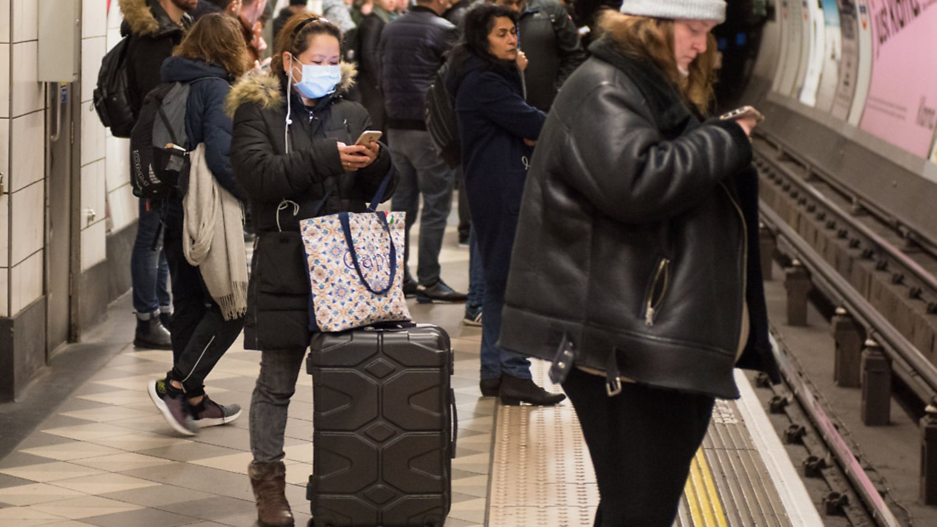 A woman wears a face mask while waiting for a tube train at Bank underground station. (photo by John Keeble/Getty Images) - Credit: Getty Images