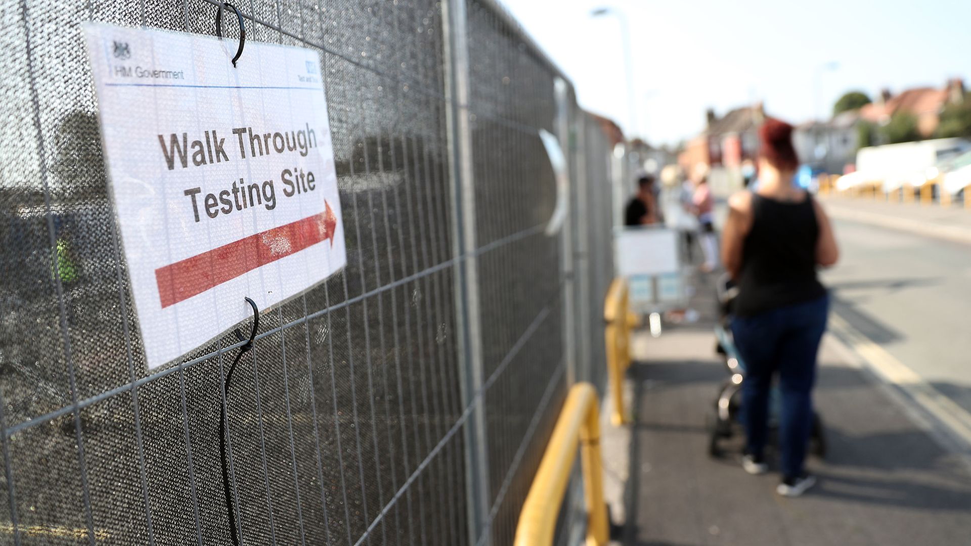 People queue up outside a walk through coronavirus testing centre - Credit: PA