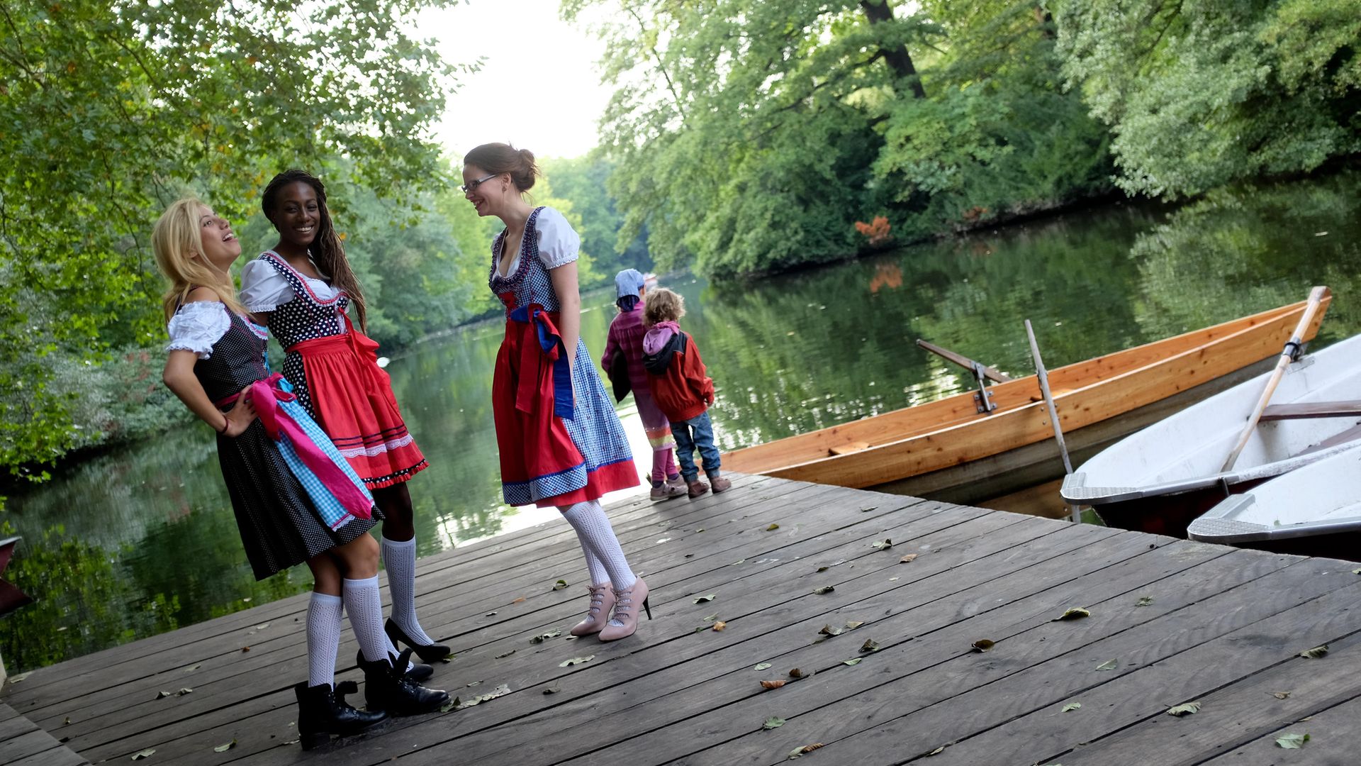 Waitresses wearing the traditional Bavarian dirndl take a break while working Munich's Oktoberfest - Credit: DPA/AFP via Getty Images