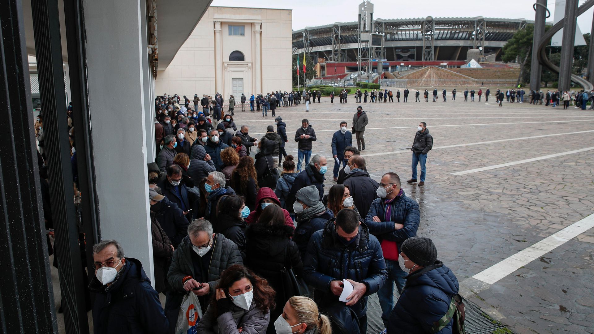 Hundreds of health workers line up to be vaccinated at a facility set up in an exhibition centre in Naples near the city's football stadium - Credit: KONTROLAB/LightRocket via Getty