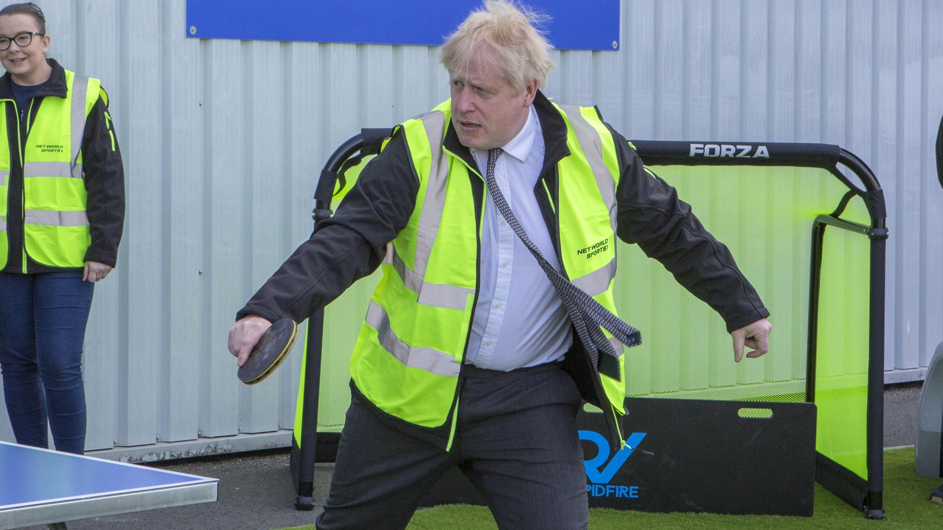 Prime Minister Boris Johnson plays table tennis during a visit to Wrexham - Credit: PA