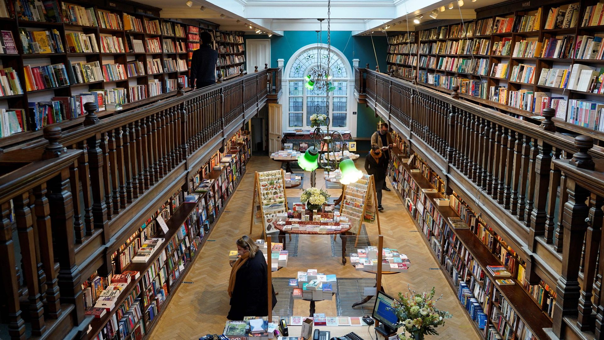 Customers wearing face masks browse for books inside the re-opened Daunt Books independent bookshop in London, after the easing of lockdown - Credit: AFP via Getty Images