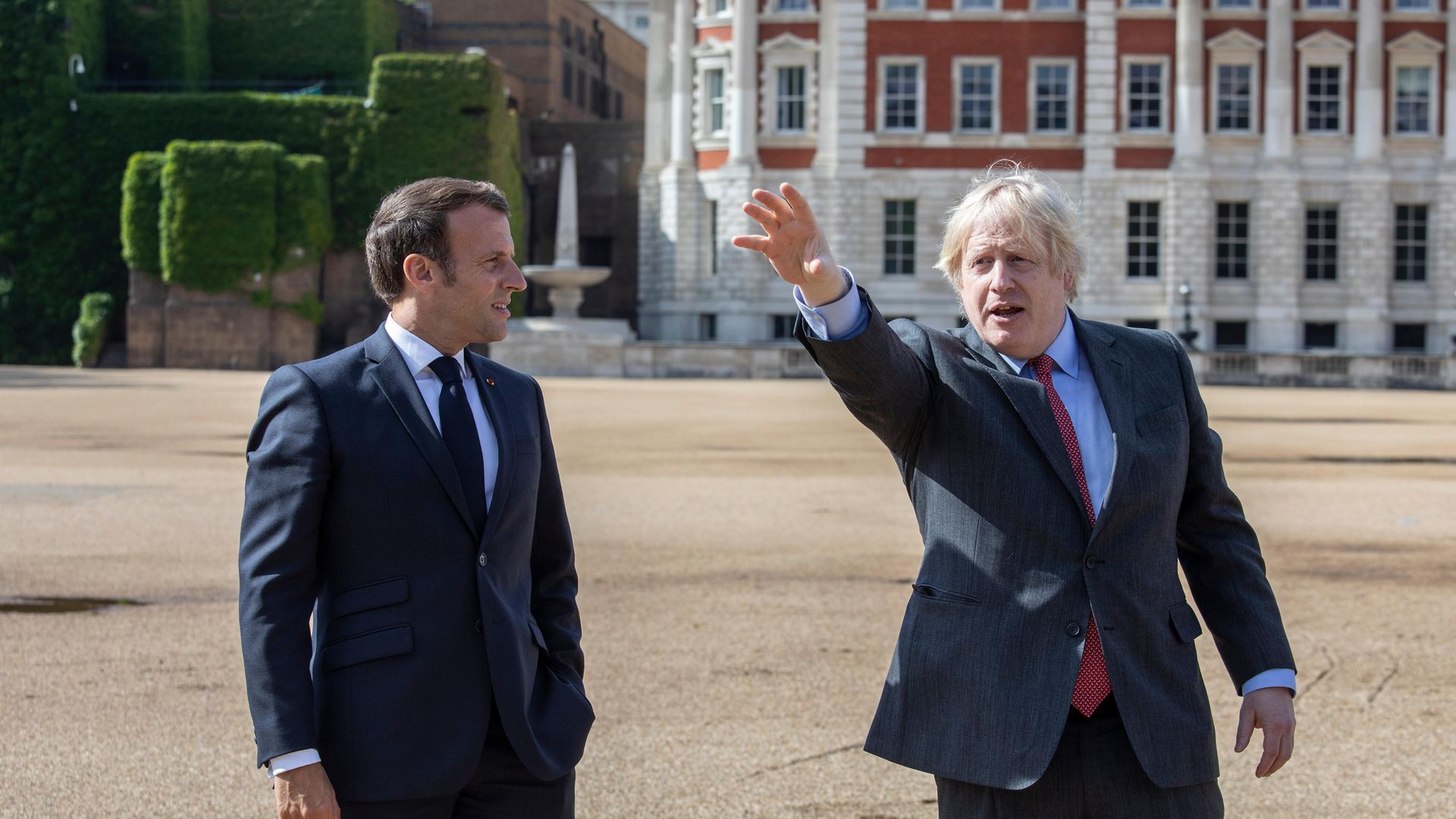 Prime minister Boris Johnson (right) and French president Emmanuel Macron watch a flypast of the Red Arrows and their French equivalent, La Patrouille de France from Horse Guards Parade in London during his visit to the UK - Credit: PA